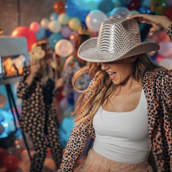 A blonde woman in a cowboy hat dancing