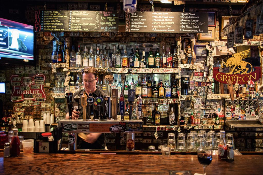 bartender pours beer from tap